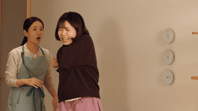 Mother hitting her daughter on back