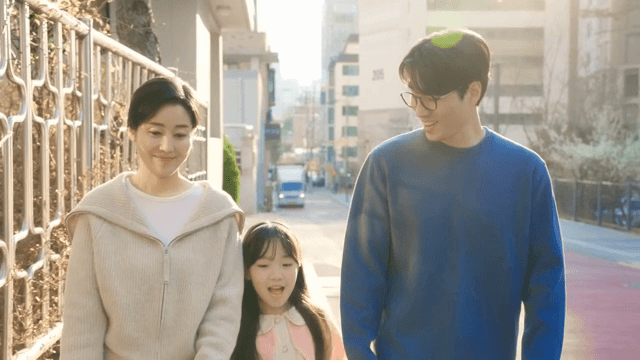 Child walking home from school with her mother and father