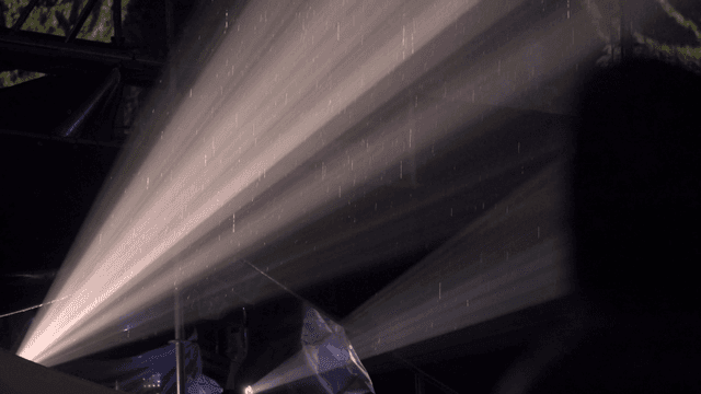 Falling rain reflected in rays of light