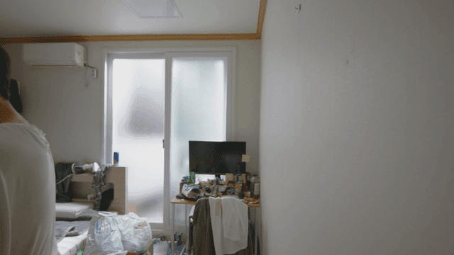 Man catching a bug in a messy room