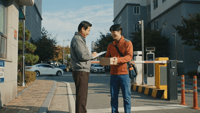 Delivery person delivering package to security guard