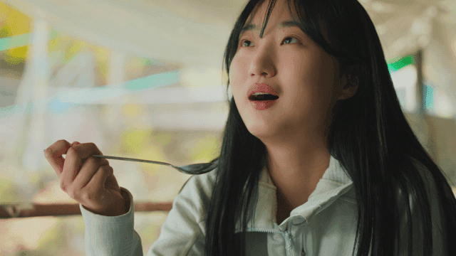 Young woman eating warm soup in forest lodge