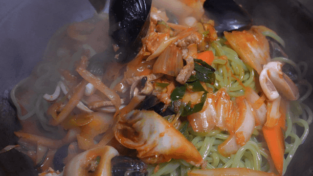 Jjamppong where seafood and broth are poured over noodles