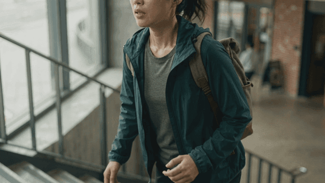 Woman climbing stairs while sweating