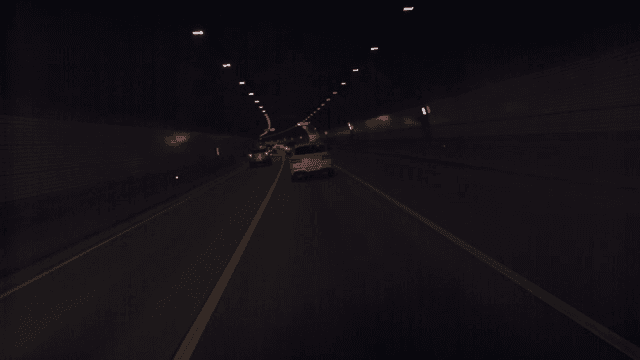 Cars driving through a dimly lit tunnel