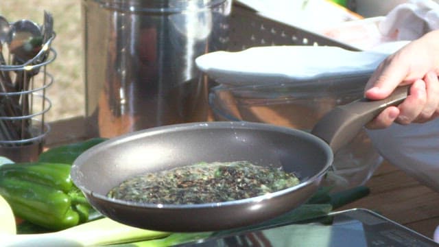 Cooking a savory pancake with laver in a pan