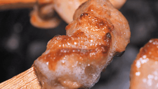 Grilled meat skewers sizzling on a grill