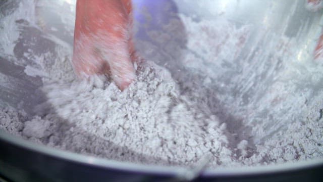 Hand-mixing starch in a large bowl