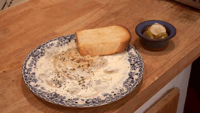 Creamy pasta with garlic bread and pickles