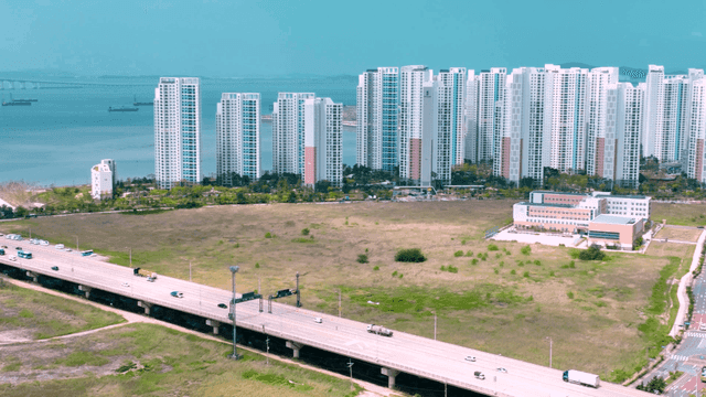Coastal city with long bridges and high-rise buildings