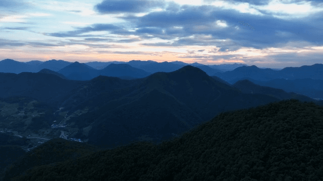 Green mountains under a clear sky