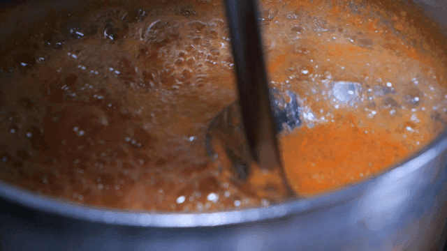 Stirring boiling tomato juice