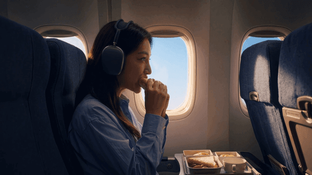 Woman eating sandwich on airplane