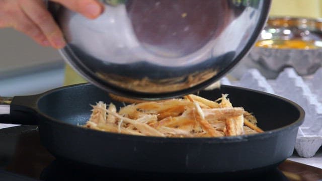 Stir-frying dried pollack in a hot frying pan