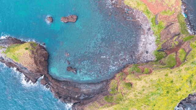 Aerial view of a rocky island with clear waters
