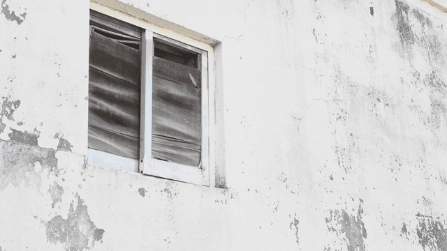 Old window on a weathered wall