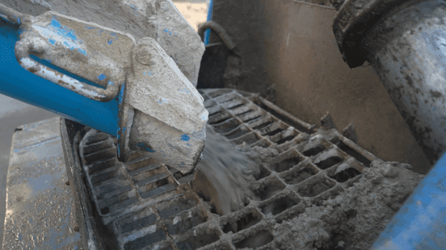 Concrete being poured from a mixer