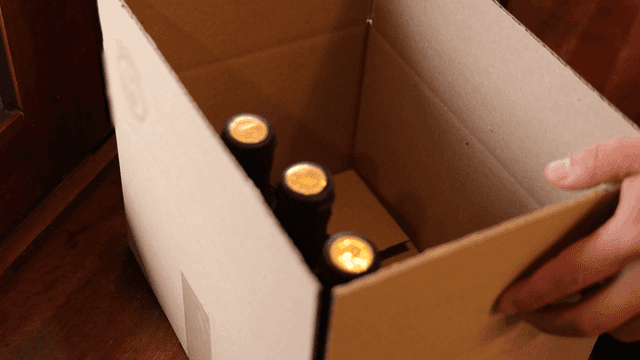 Bottle of sesame oil is placed in paper box
