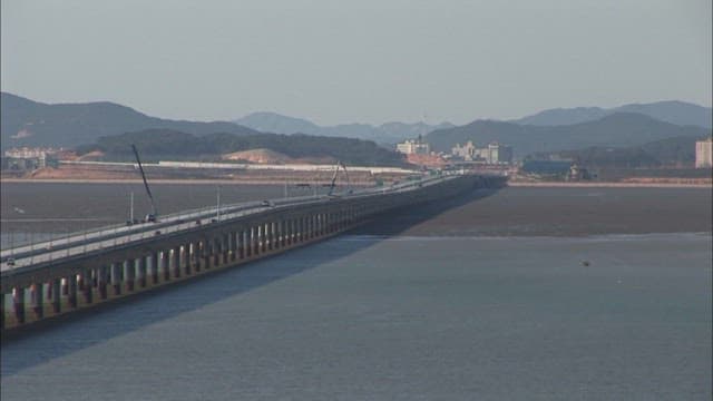 Tidal flats exposed as the sea water recedes under Incheon Bridge