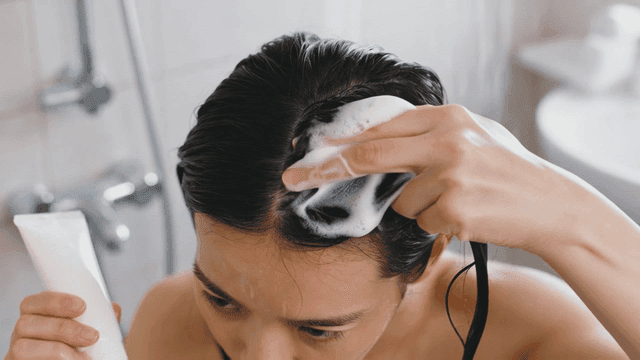 Applying hair treatment in the shower