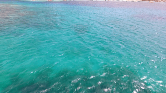 Clear turquoise sea with distant shore