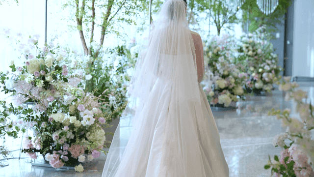 Back view of bride in wedding dress surrounded by flowers