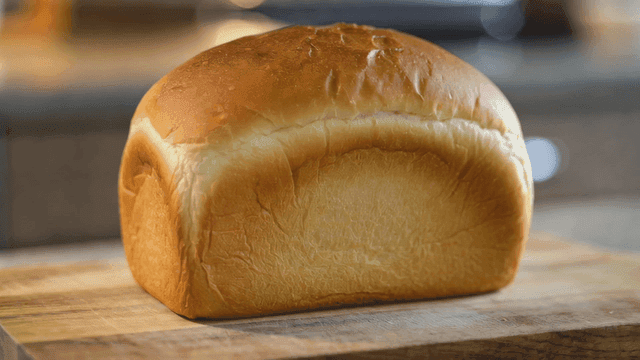 Freshly baked loaf of bread on a wooden board
