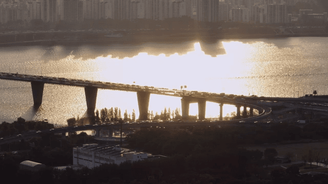 Bridge over a river with city skyline