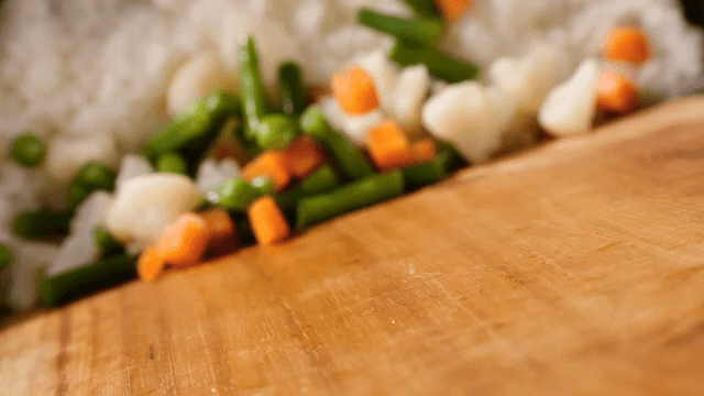 Vegetables falling on rice