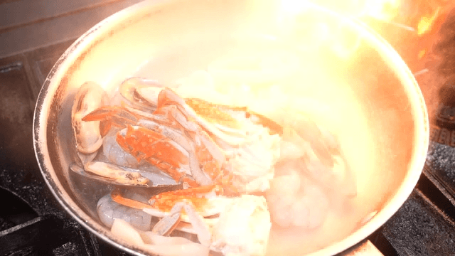 Seafood being cooked in a hot pan