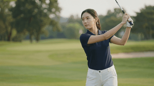 Woman playing golf on clear day