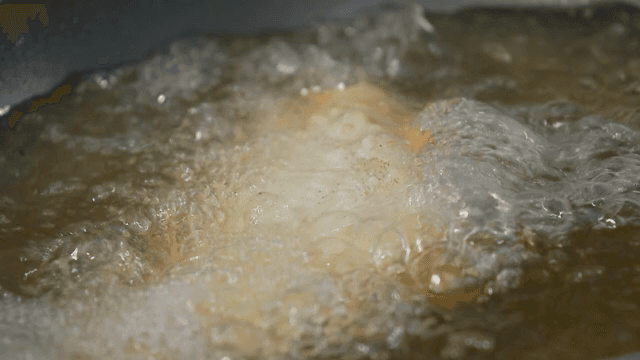 Fish being fried in hot oil