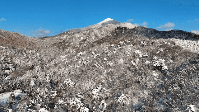 Snow-covered mountains under a clear blue sky