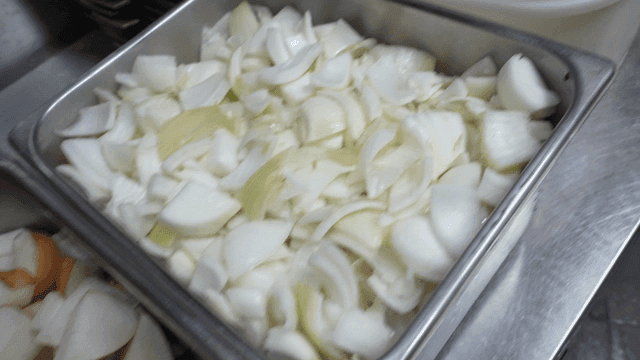 Kitchen containers filled with dried shrimp, garlic, onions, and pears