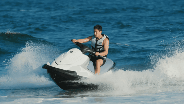 People riding jet skis in sea