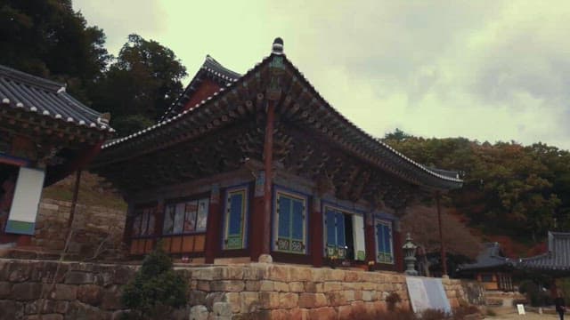 Traditional Korean temple against autumn hills