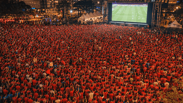 Large crowd watching a soccer match outdoors