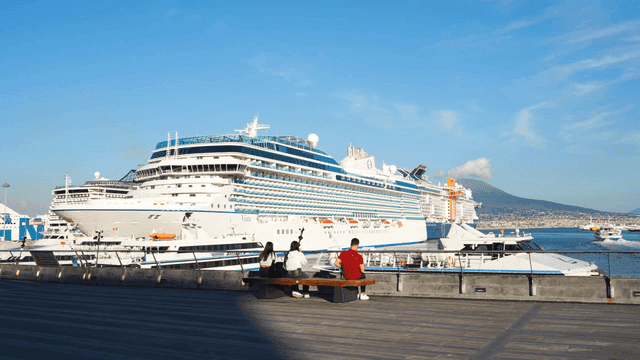 Large cruise ship docked at a sunny port