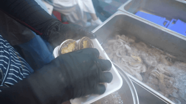 Abalone being taken out of steamer