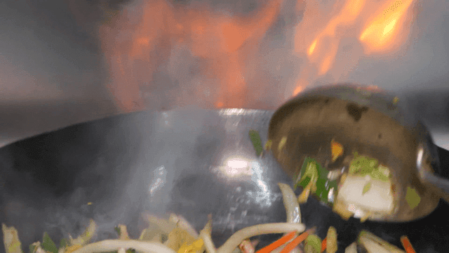 Stir-fry vegetables in hot wok