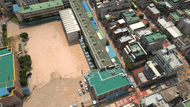 Aerial view of a school and surrounding city