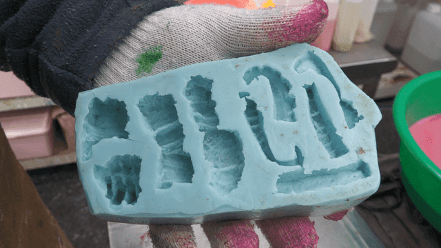 Worker holding a silicone mold