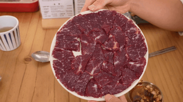 On table placed raw Korean beef chunk plate