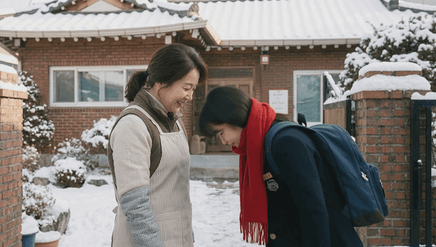 Daughter going to school after greeting her mother