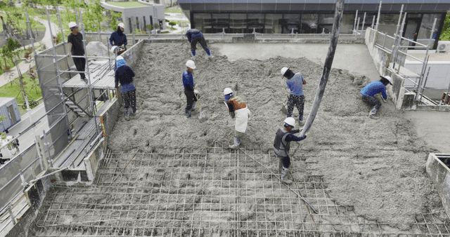 Workers pouring concrete on a building site