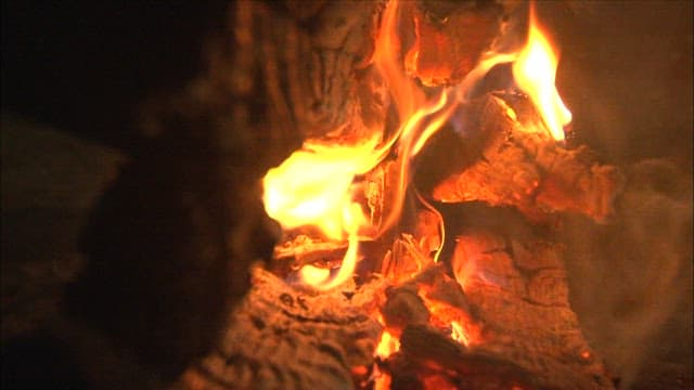 Log fire burning brightly, illuminating the night