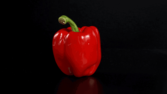 Fresh red bell pepper on a dark background