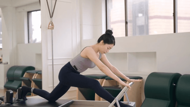 Woman practicing pilates on a reformer