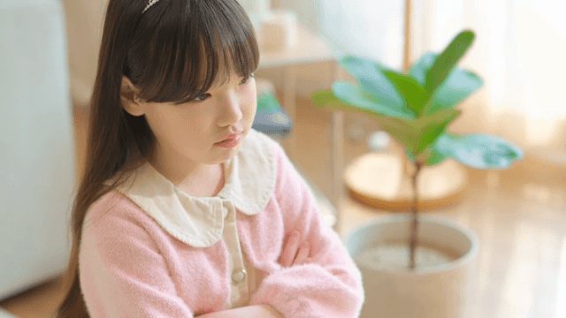 Sulky child with her arms crossed