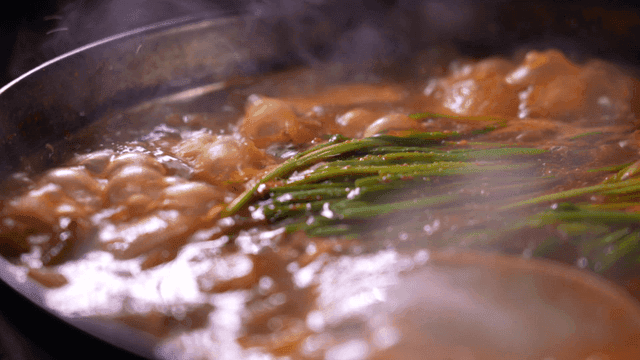 Steam rising from boiling tripe stew